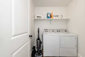 Washroom featuring washing machine and clothes dryer