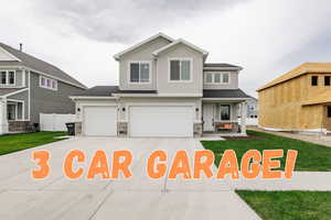 View of front of home featuring a garage and a front yard