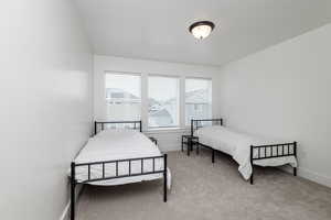 Bedroom with light colored carpet