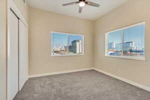 Unfurnished bedroom with a closet, light colored carpet, and ceiling fan