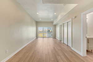 Corridor with light hardwood / wood-style flooring