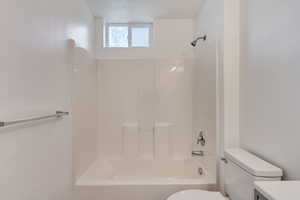 Full bathroom featuring vanity, toilet, and shower / tub combination