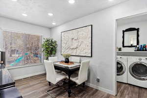 Dining room with hardwood / wood-style floors and washing machine and clothes dryer