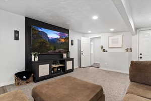 Home theater room featuring a textured ceiling