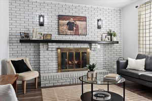 Living room featuring a fireplace and wood-type flooring