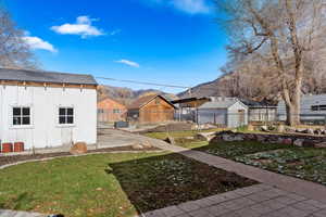 View of yard with a patio area and a storage shed