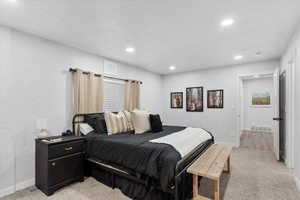 Bedroom featuring light colored carpet