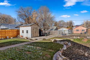 View of yard featuring a storage unit