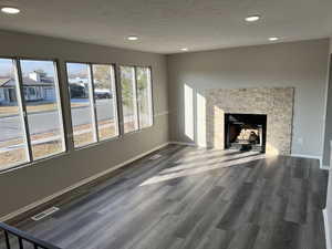 Unfurnished living room featuring plenty of natural light and hardwood / wood-style floors