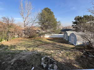 View of yard with a storage unit