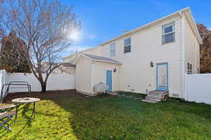 Back of house featuring a lawn