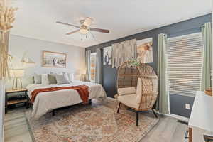 Bedroom featuring ceiling fan and light wood-type flooring