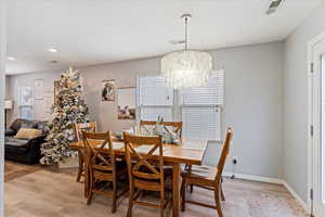 Dining area featuring a chandelier and light hardwood / wood-style flooring