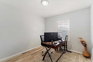 Office area with light hardwood / wood-style floors