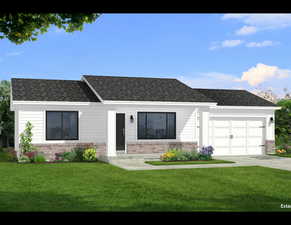View of front of property featuring a garage and a front lawn