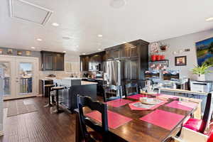 Dining space with french doors, dark wood-type flooring, and a textured ceiling