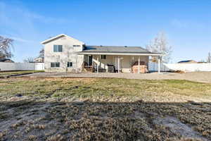 Back of house with a lawn