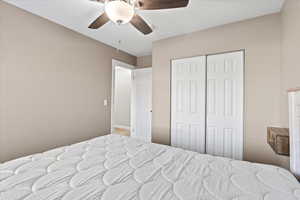 Bedroom with ceiling fan and a closet