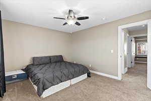 Carpeted bedroom with ceiling fan