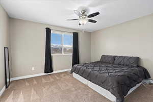 Carpeted bedroom with ceiling fan