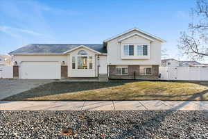 View of front facade with a front yard and a garage