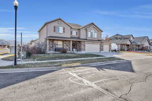 Front of property featuring central AC unit and a garage