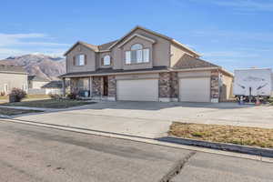 View of front property with a mountain view and a garage