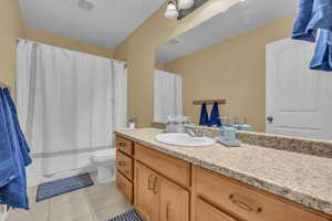 Bathroom featuring tile patterned floors, vanity, and toilet