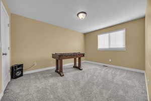 Game room featuring light colored carpet