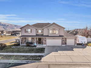 View of front property with a mountain view and a garage