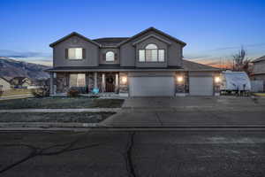 View of front property with a mountain view and a garage