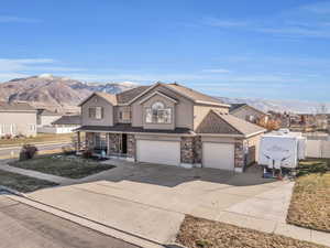 Front facade with a mountain view and a garage