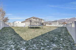 View of yard with a mountain view and a trampoline