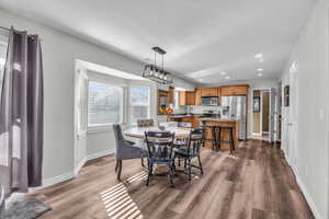 Dining area with dark hardwood / wood-style floors