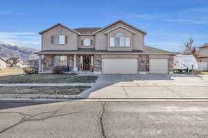 Front facade with a mountain view and a garage