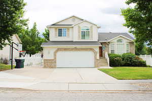 Split level home with a front yard and a garage