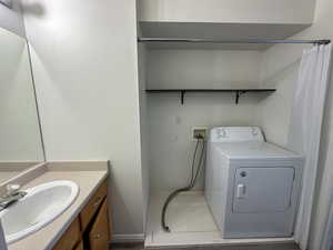 Laundry area with sink and washer / dryer