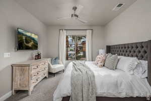 Carpeted bedroom with access to outside and ceiling fan