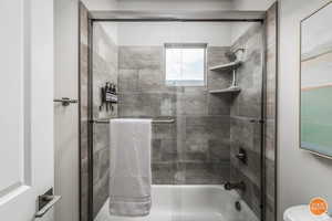 Bathroom with enclosed tub / shower combo