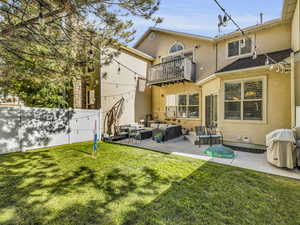 Rear view of house, fully fenced backyard and patio area