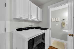 Laundry area with cabinets