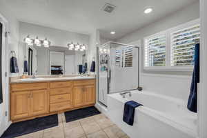 Primary Bathroom with separate tub/shower and dual sinks