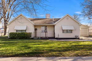 View of front of home featuring a garage and a front lawn