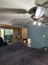 Carpeted bedroom with ceiling fan