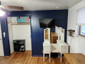 Home office with ceiling fan and wood-type flooring