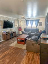 Living room with ceiling fan and hardwood flooring