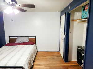 Bedroom with hardwood / wood-style flooring and ceiling fan