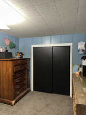 Carpeted bedroom with a closet