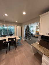 Dining space with light hardwood / wood-style flooring