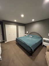 Carpeted bedroom featuring multiple closets